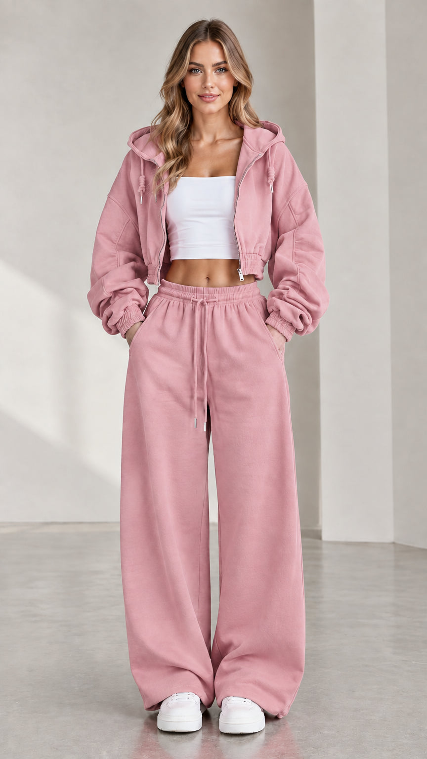 Woman wearing dusty pink cropped zip hoodie and matching wide-leg sweatpants