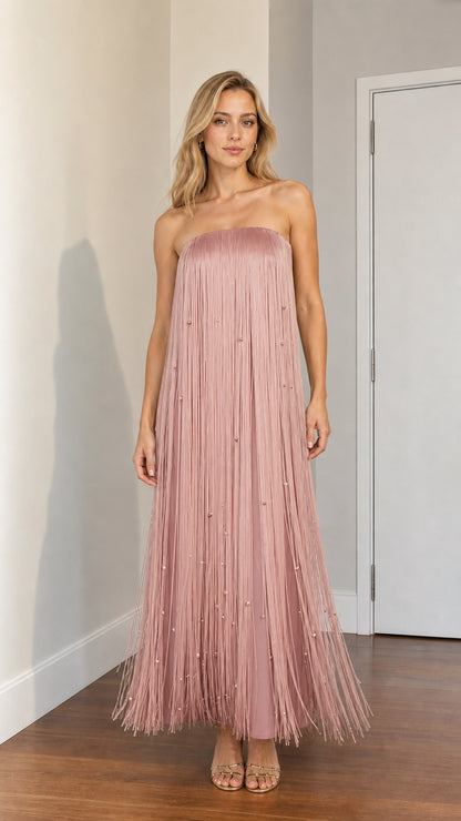 Woman wearing dusty pink strapless beaded fringe maxi dress