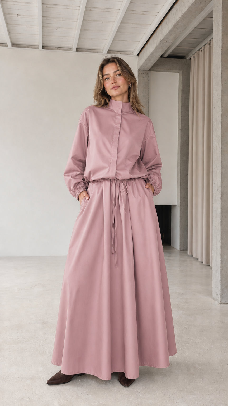 Front full view of woman wearing dusty pink stand collar drawstring maxi dress