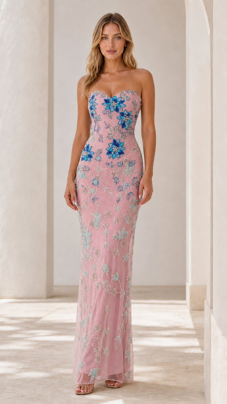 Front view of blush pink strapless gown with blue floral embroidery