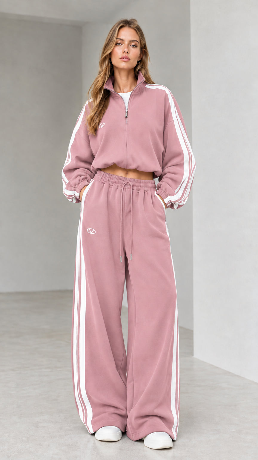Front view of woman wearing dusty pink cropped quarter-zip tracksuit set