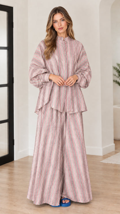 Woman wearing dusty pink vertical striped tunic top and wide leg pants set