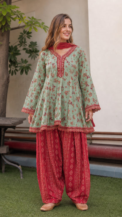Model wearing mint green floral peplum tunic with red dhoti pants