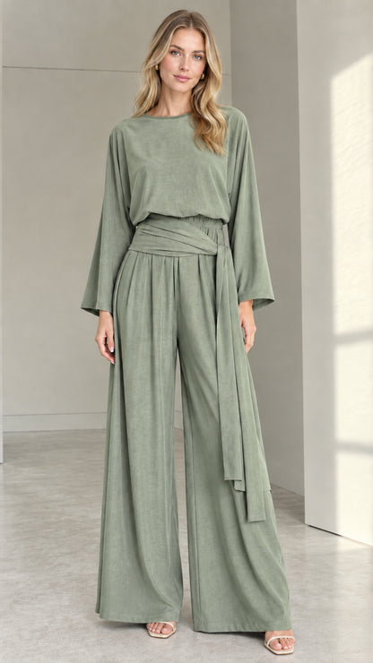 Front full view of woman wearing sage green long-sleeve wide-leg jumpsuit