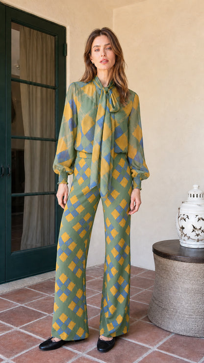 Model wearing sage green colorway of the plaid matching set
