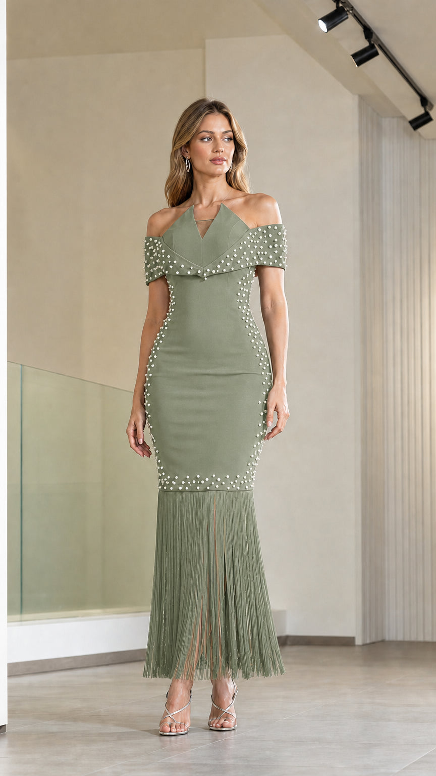 Model wearing sage green off-the-shoulder pearl embellished fringe evening dress