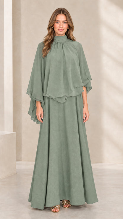 Front view of woman wearing sage green mock neck capelet maxi dress