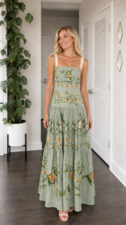 Front view of model wearing sage green floral embroidered tiered maxi dress
