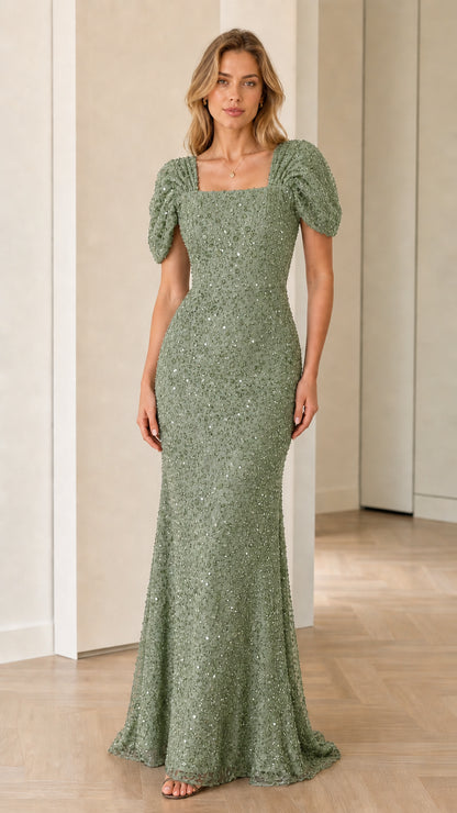 Front view of model wearing sage green sequin evening gown with puff sleeves