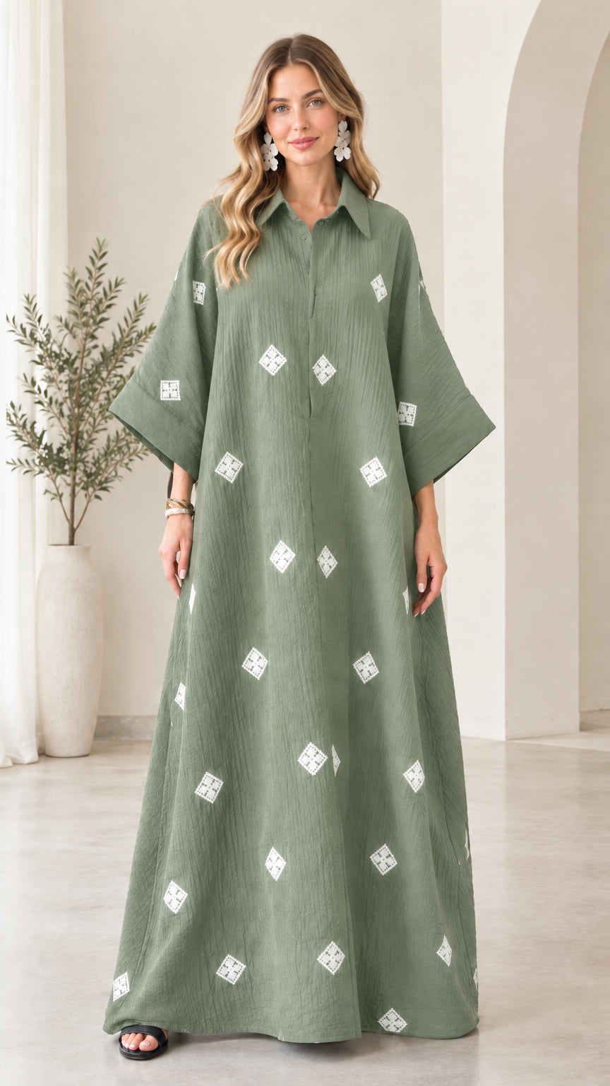 Front view of model wearing sage green embroidered crinkle maxi shirt dress