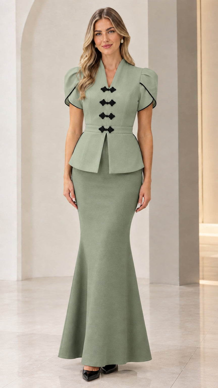 Front full view of woman wearing sage green peplum top and matching mermaid maxi skirt set