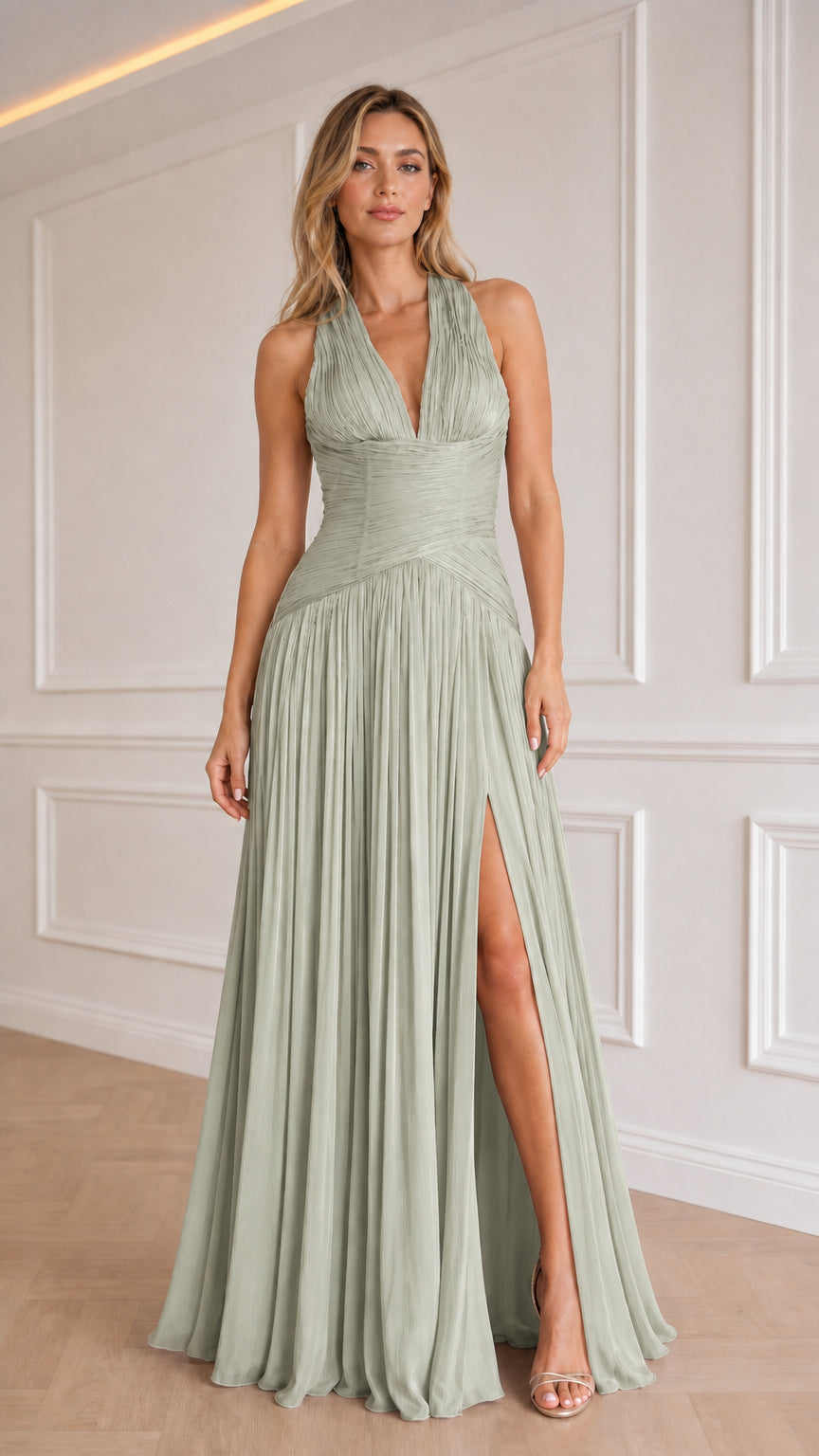 Model wearing sage green color variant of the halter pleated evening dress