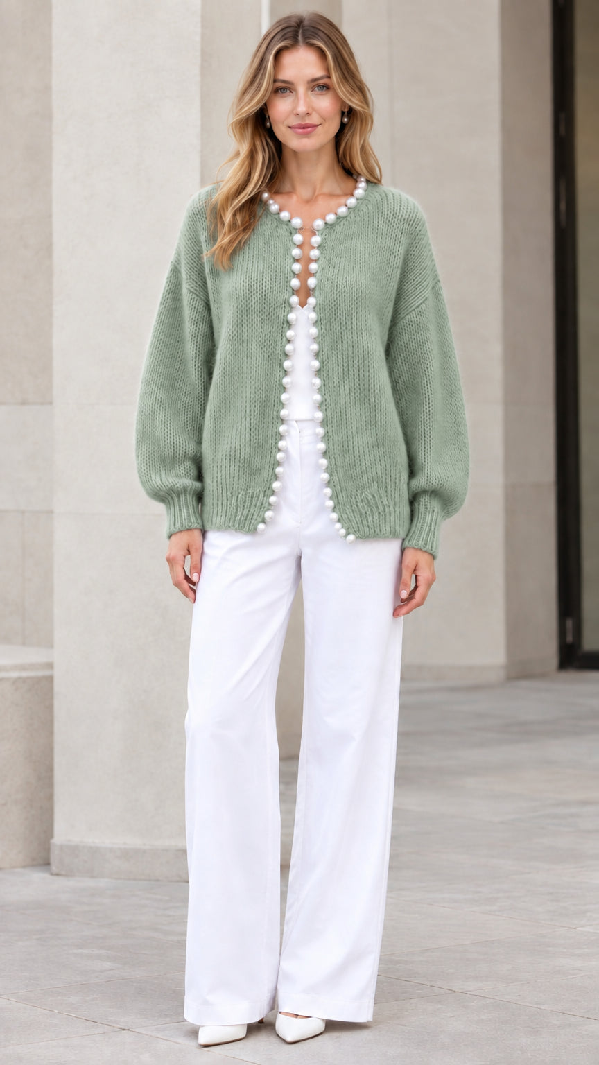 Model wearing Sage Green pearl-trimmed knit cardigan sweater with white trousers