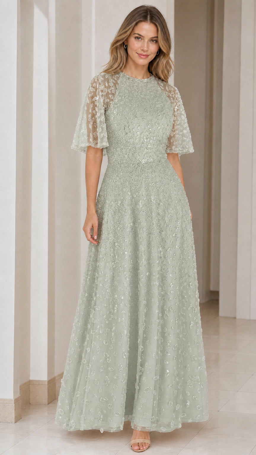 Woman wearing sage green sequin embroidered A-line formal maxi dress