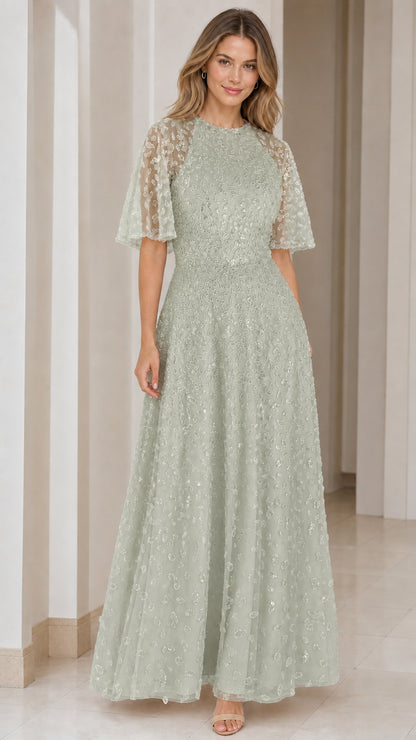 Woman wearing sage green sequin embroidered A-line formal maxi dress