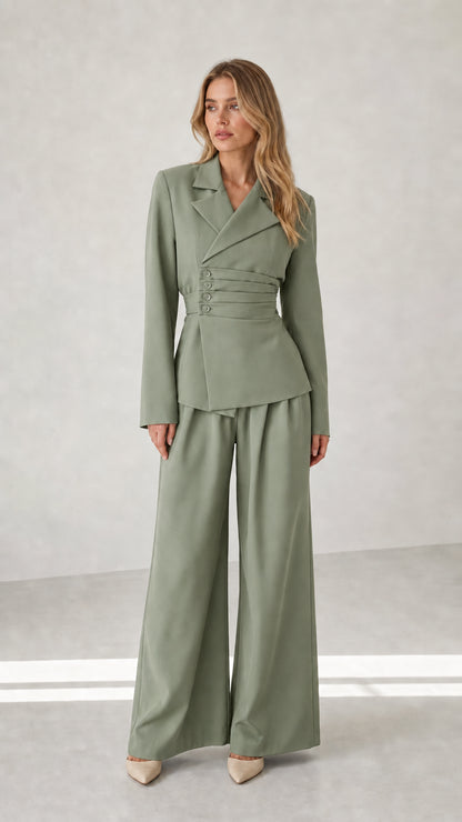 Woman wearing sage green tailored blazer and wide leg trousers set