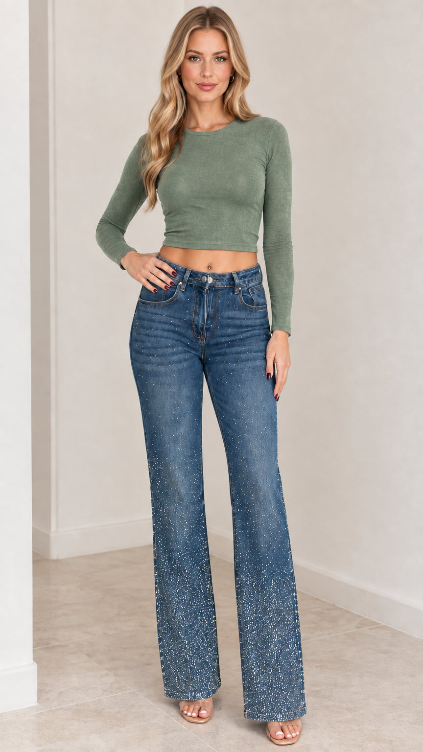 Model wearing rhinestone flare jeans paired with an olive green long-sleeve crop top