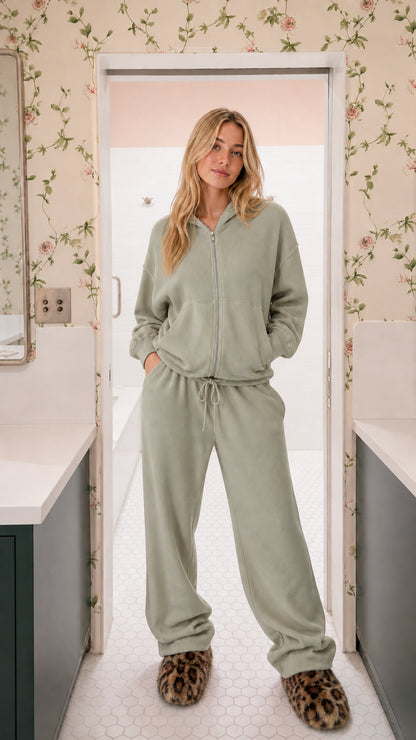 Model wearing sage green two-piece ribbed knit zip-up hoodie and wide-leg sweatpants set