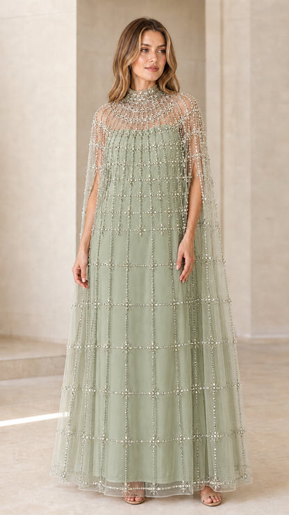 Front view of model wearing Sage Green embellished cape maxi gown