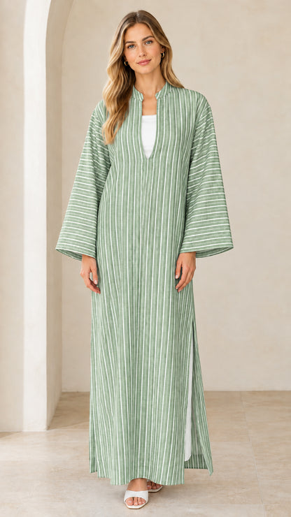 Woman wearing sage green vertical striped maxi kaftan dress