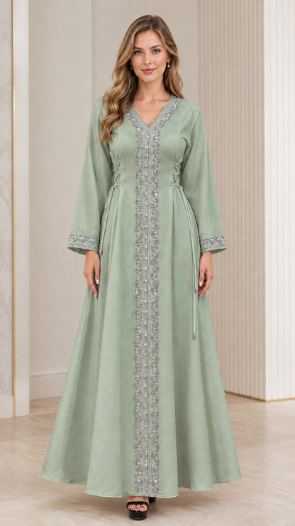 Full-length view of woman wearing sage green embroidered modest kaftan gown