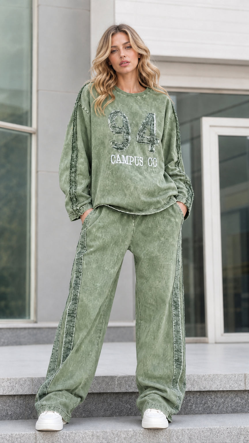 Full-length front view of sage green mineral washed graphic tracksuit set with wide leg pants