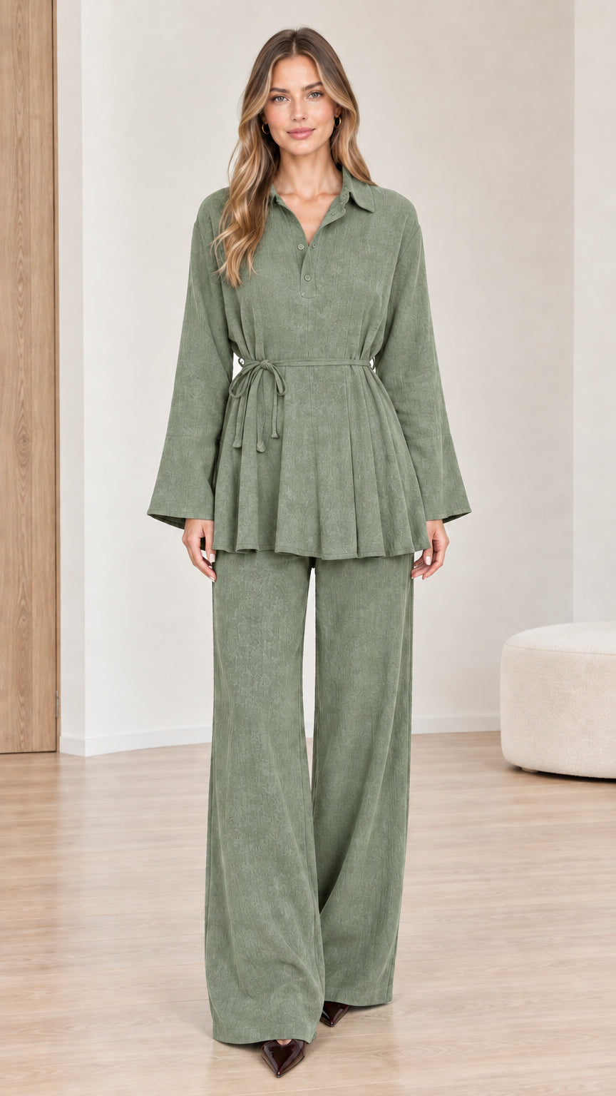 Front view of woman wearing sage green belted peplum top and wide-leg pants set
