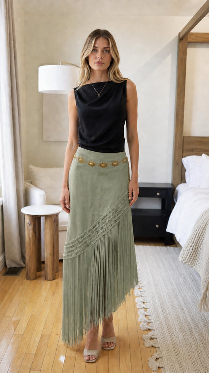 Woman wearing sage green bohemian fringe long skirt