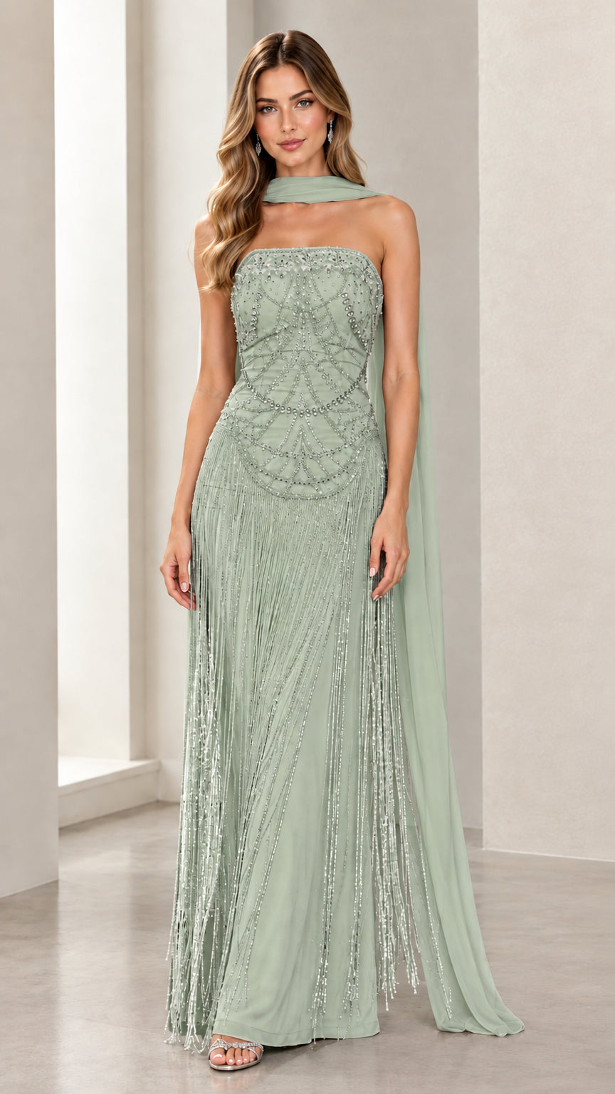 Front view of model wearing Sage Green strapless beaded fringe evening gown with green scarf cape