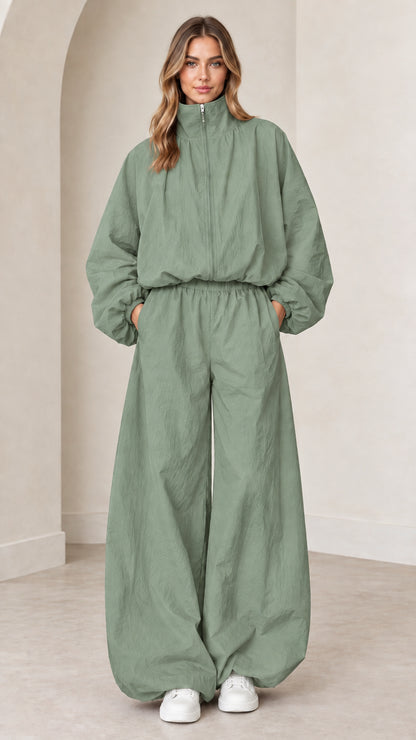 Model wearing sage green funnel neck parachute tracksuit jumpsuit