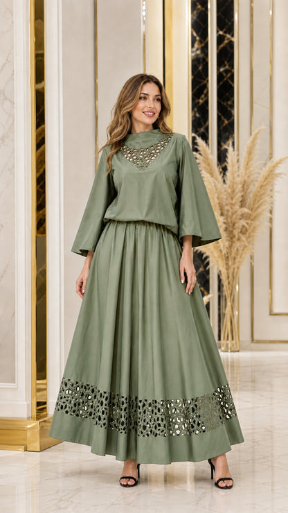 Woman wearing sage green wide sleeve top and coordinating maxi skirt set