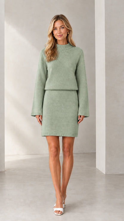 Front view of woman wearing sage green knit sweater and mini skirt set