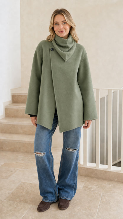 Front view of woman wearing sage green asymmetrical cowl neck jacket