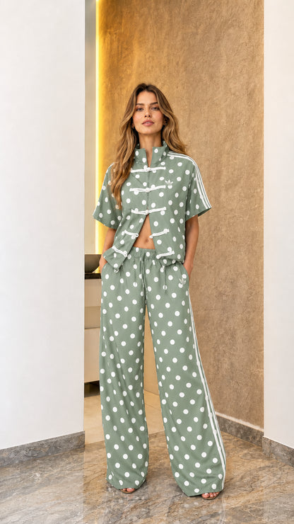 Model wearing sage green polka dot track set