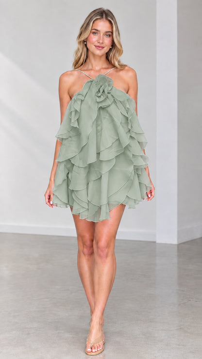 Front view of model wearing Sage Green tiered ruffle halter mini dress