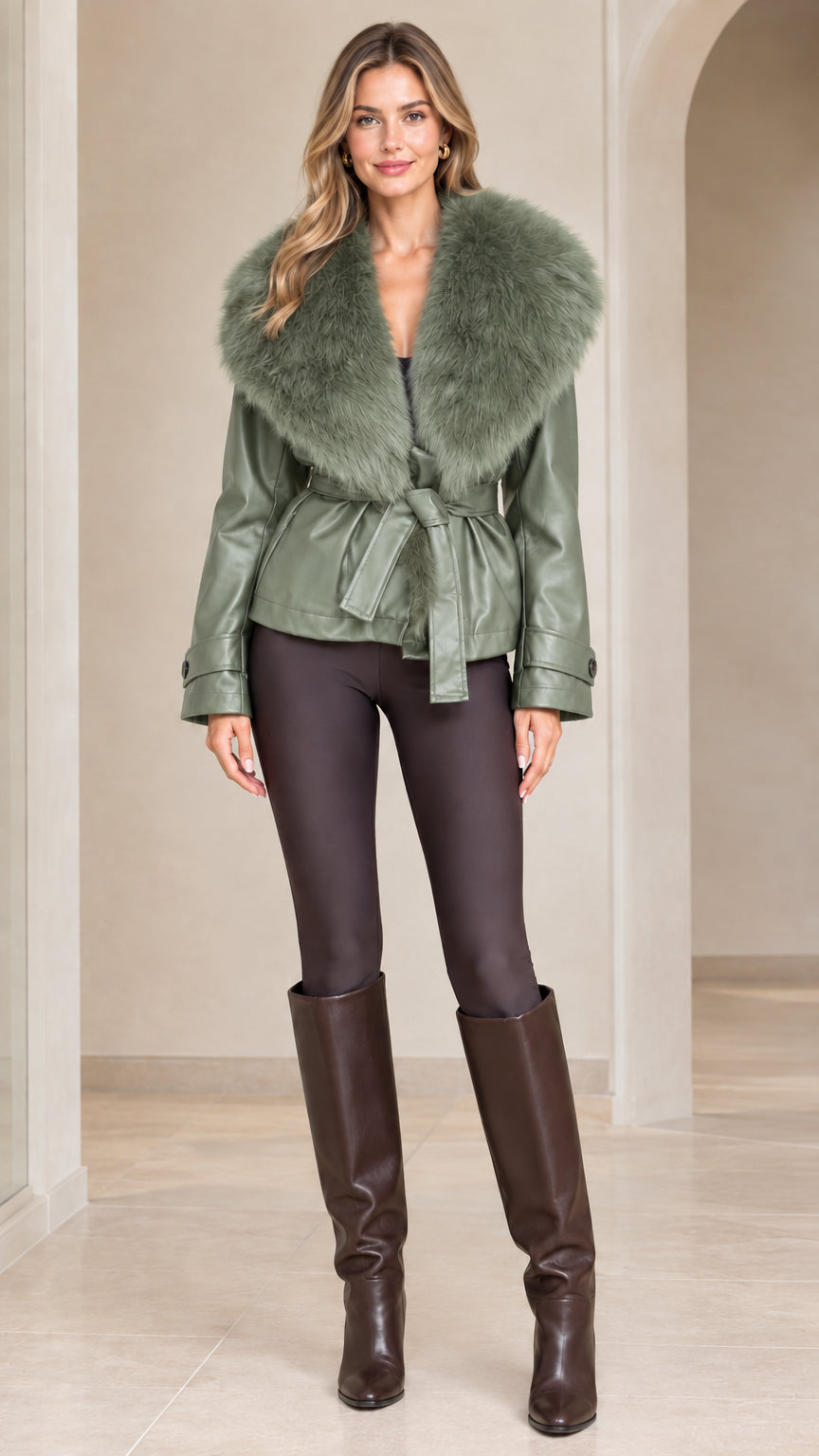 Front view of model wearing sage green faux leather jacket with matching green fur collar