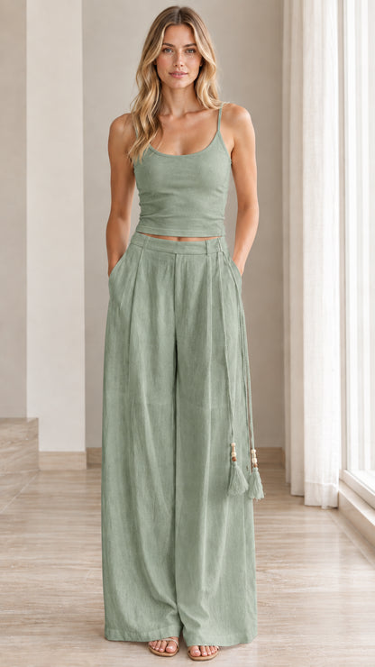 Front view of model wearing sage green two-piece cami and flowy trousers set