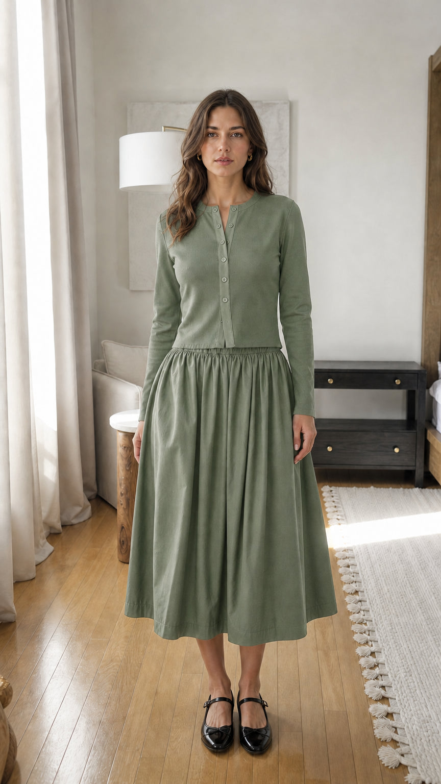 Woman wearing sage green long-sleeve ribbed top and midi skirt set