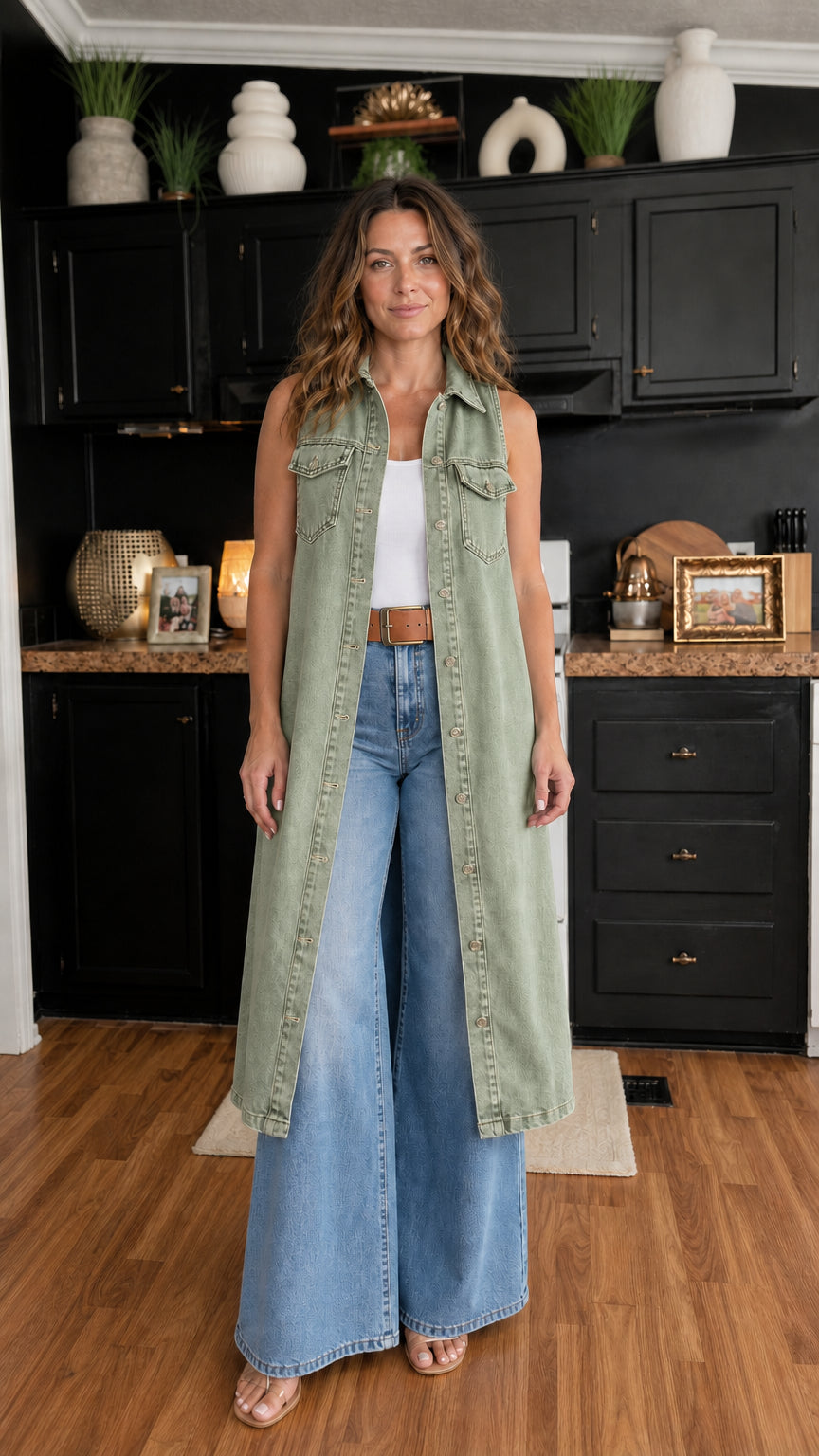 Woman wearing olive green longline denim vest over white top