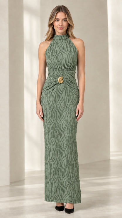 Front view of woman wearing sage green textured column maxi dress with brooch