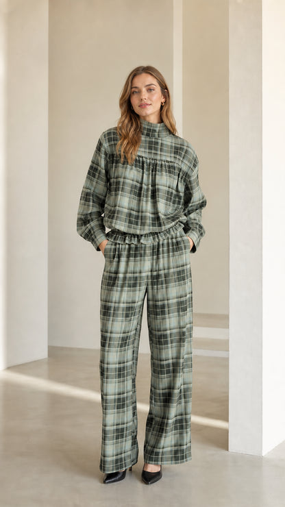 Model wearing sage green plaid mock neck blouse and matching wide leg pants