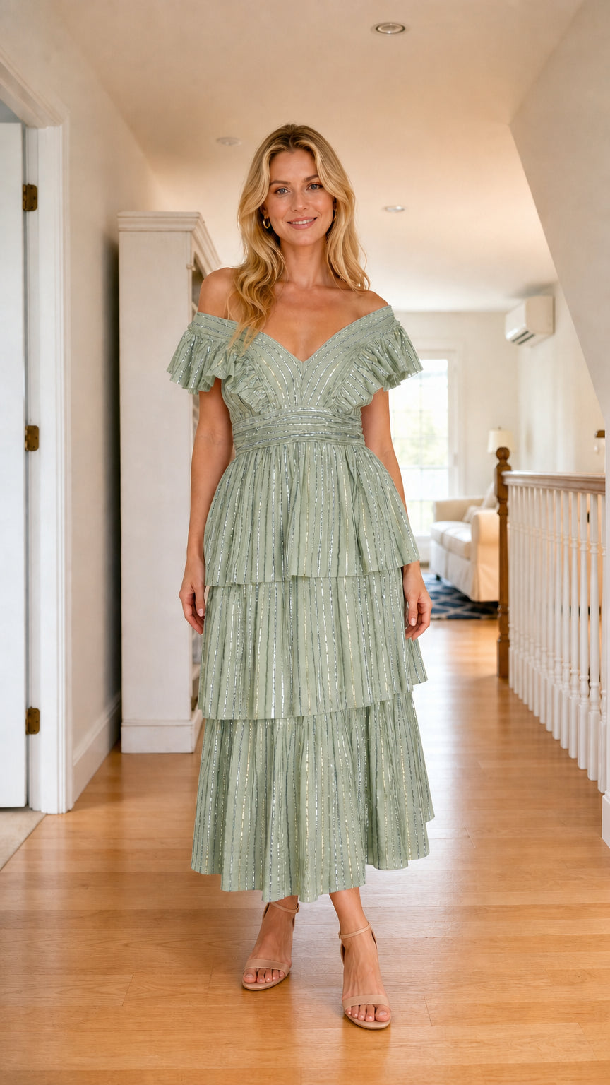 Front view of model wearing sage green off-shoulder ruffle tiered sequin midi dress