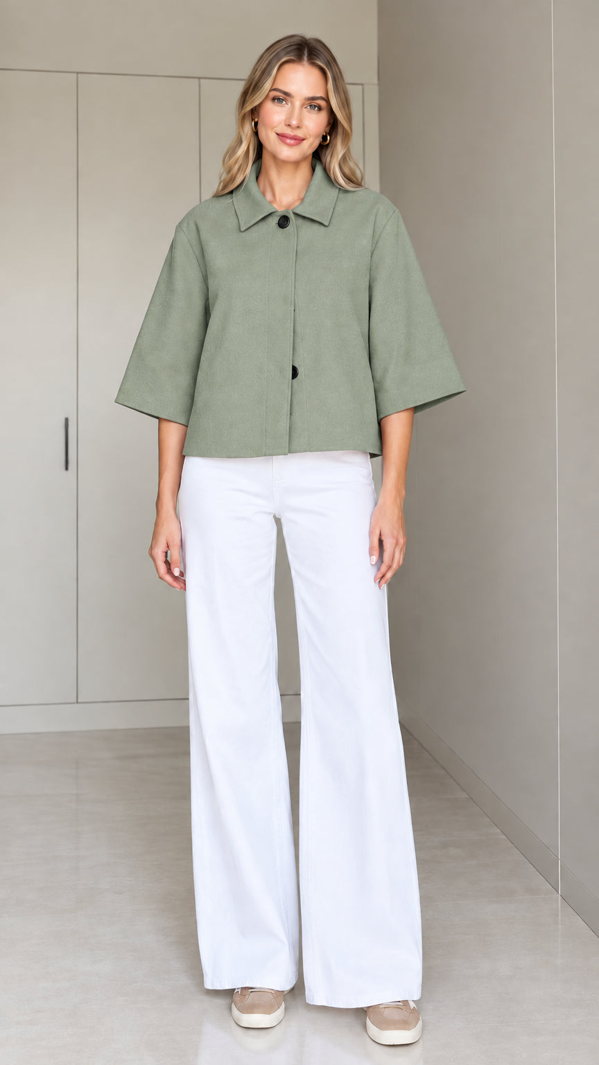 Front view of a woman wearing the cropped half-sleeve swing jacket in sage green