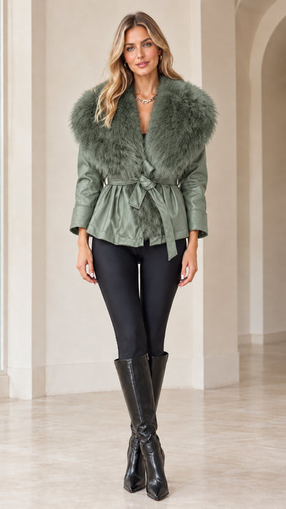 Front view of model wearing sage green faux leather jacket with matching green faux fur collar