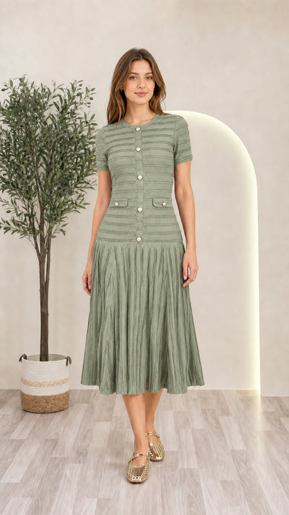 Model wearing sage green short sleeve pleated knit midi dress