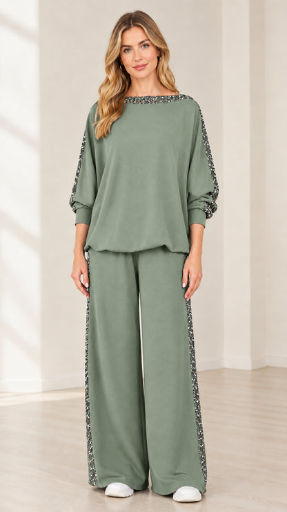 Woman wearing sage green 2-piece matching top and wide-leg trousers set