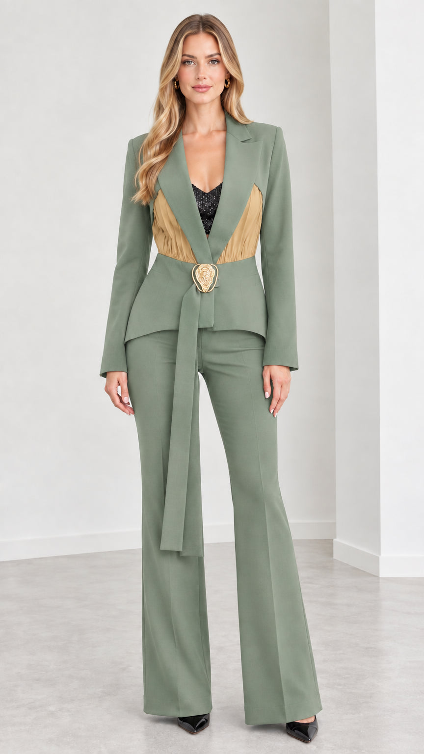 Model wearing sage green contrast pleated blazer and flare trousers set
