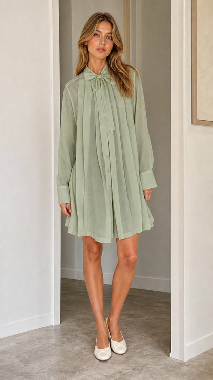 Front full view of sage green pleated shift dress