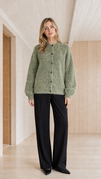 Model wearing sage green fuzzy crewneck button-front cardigan sweater