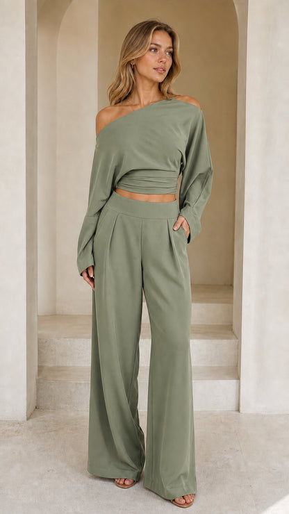 Full front view of model wearing sage green off-shoulder crop top and wide-leg pant set